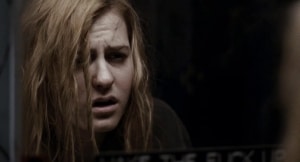 Scout Taylor-Compton Says She Is “Kinda Glad” Third ‘HALLOWEEN’ Was Never Made Distressed woman looking into a mirror.