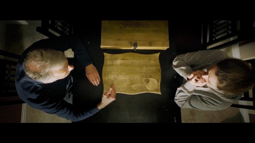 Laurie (Roger Shepherd) and Indi (Lois Wilkinson) use the ouijaboard - Copy