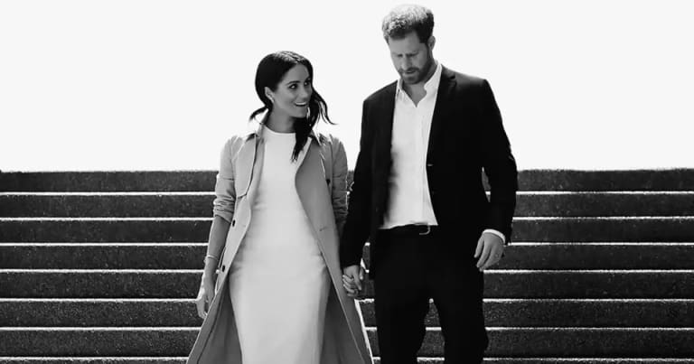 Prince Harry and Meghan Markle Sign Multiyear Deal With Netflix A man and woman walking down steps together, holding hands.