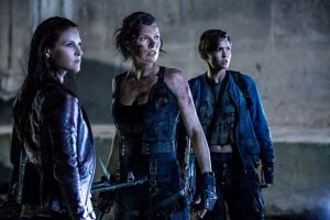 Three individuals, with a serious expressions and holding weapons, stand together in a dimly lit, rugged environment. They appear to be ready for a confrontation.
