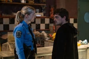 A man and a woman standing in front of a counter.