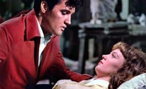 Elvis presley and a woman in a hospital bed.
