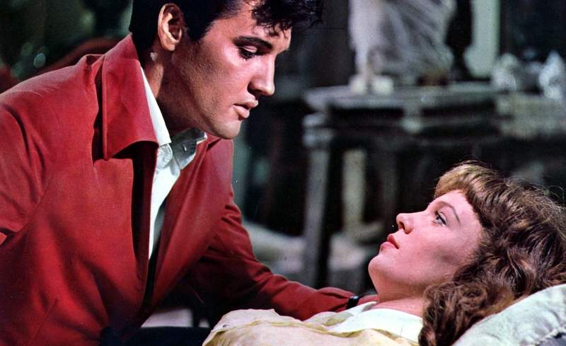 Elvis presley and a woman in a hospital bed.