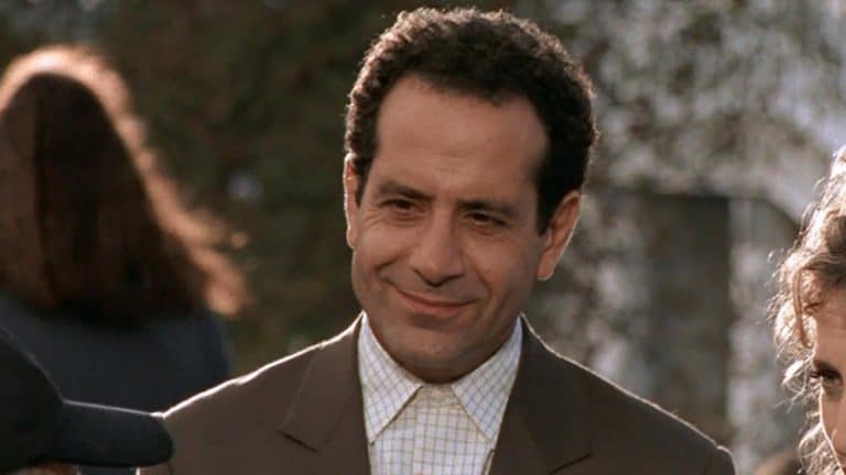 A man in a suit and a woman standing next to each other.