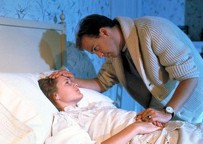 A man and a woman in a bed.