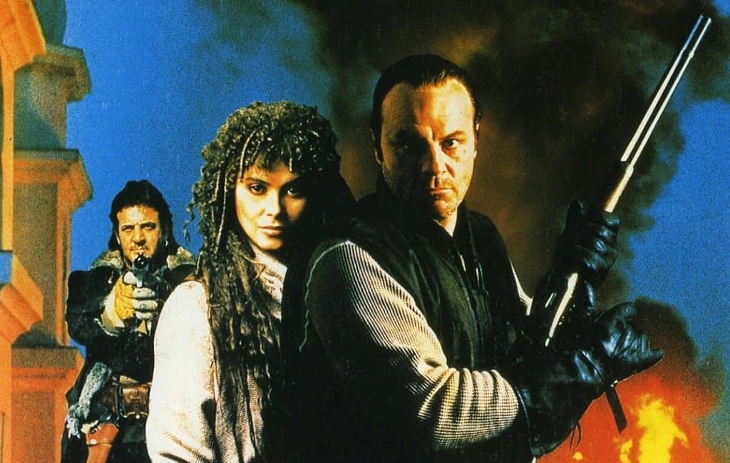 A movie poster with two people holding guns in front of a fire.