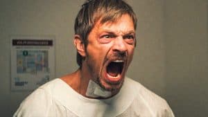 A man yelling in a hospital room.