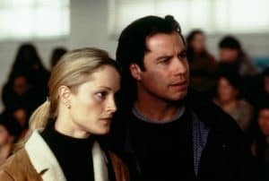 A man and woman standing next to each other in a classroom.