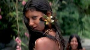 ‘The Emerald Forest’ (Special Edition) Blu-Ray Review – An Unexpected Indigenous Exploration A woman with flowers in her hair is standing next to a river.