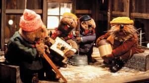 A group of teddy bears sitting on a bench.