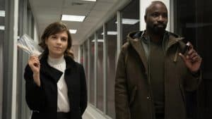 A man and a woman standing in a hallway.