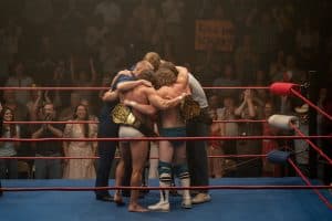 A group of people hugging in a wrestling ring.