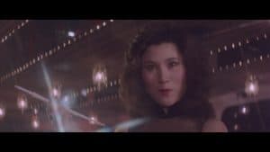 ‘Kill Butterfly Kill’ Blu-Ray Review – Revenge With A Healthy Dose Of Exploitation A woman in a black dress holding a wand.