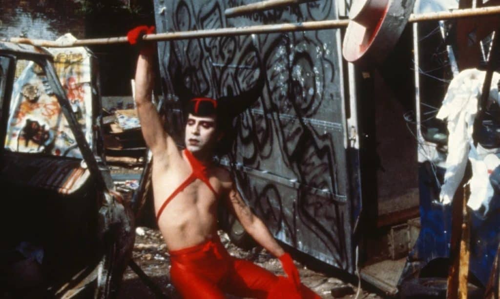 A man in a red outfit holding a bat.