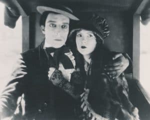 The Buster Keaton Collection: Volume 5 Blu-Ray Review – Amusing Silent-Era Efforts From The Great Stone Face A black and white photo of a man and woman on a train.