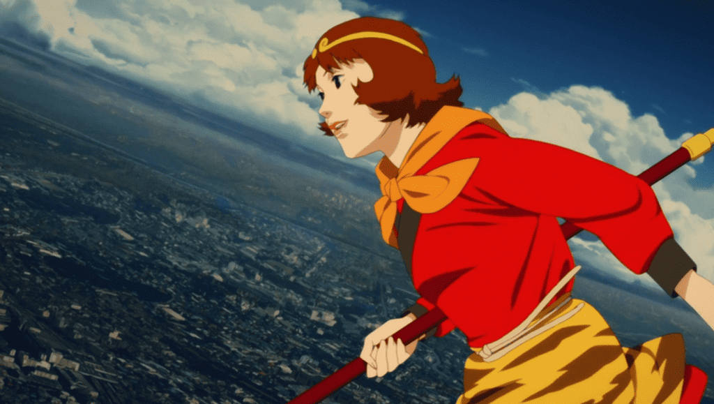 A girl in a red dress is flying over a city.