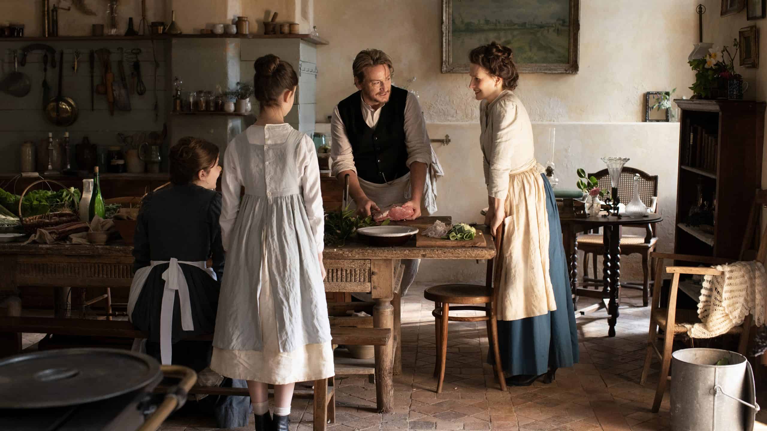 A group of people in a kitchen preparing food.
