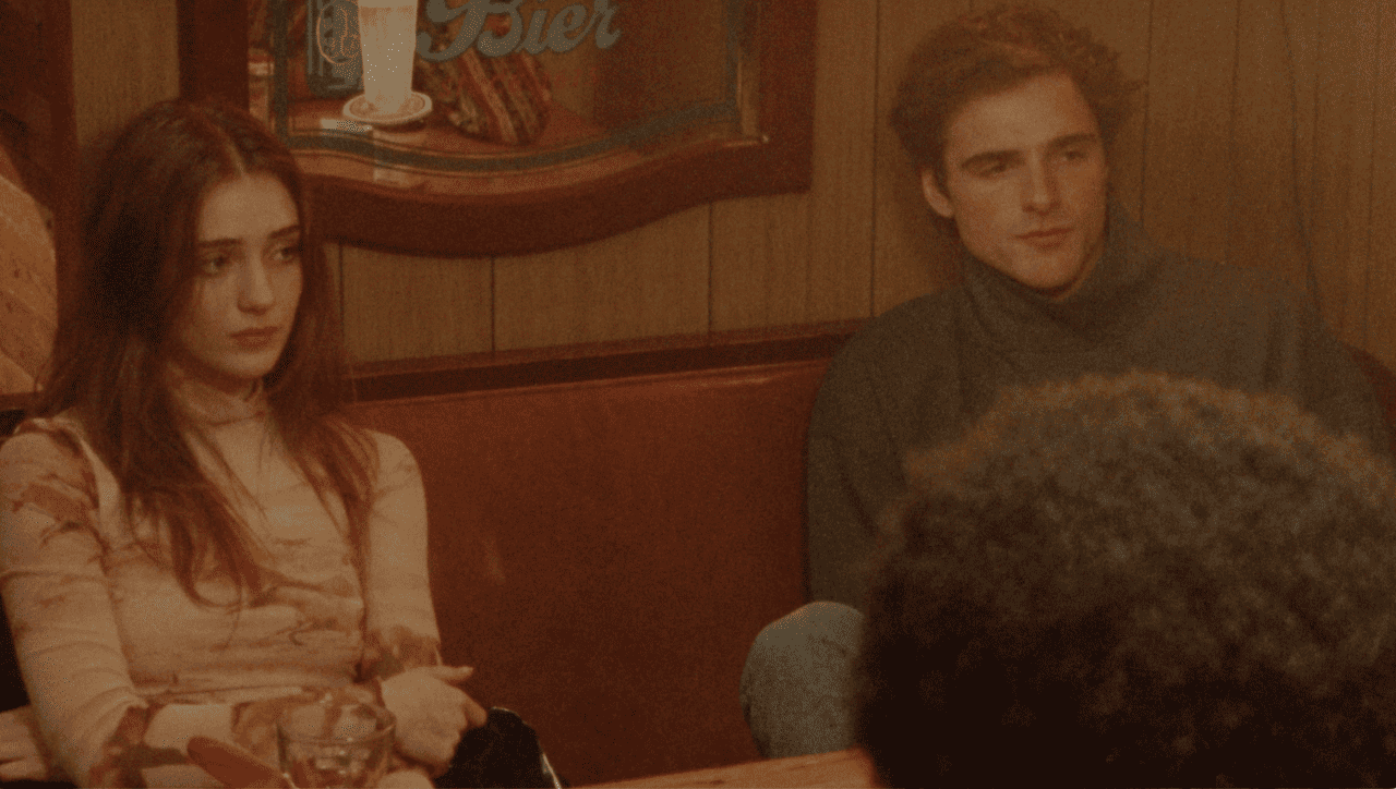 A group of people sitting at a table in a restaurant.