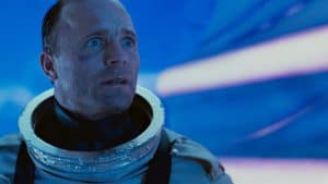 A man in a space suit looking at the camera.