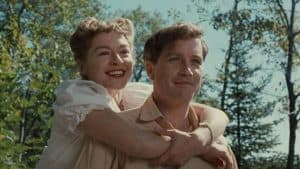 ‘The Apprenticeship Of Duddy Kravitz’ Blu-Ray Review – Success At All Costs A man and woman hugging each other in the woods.