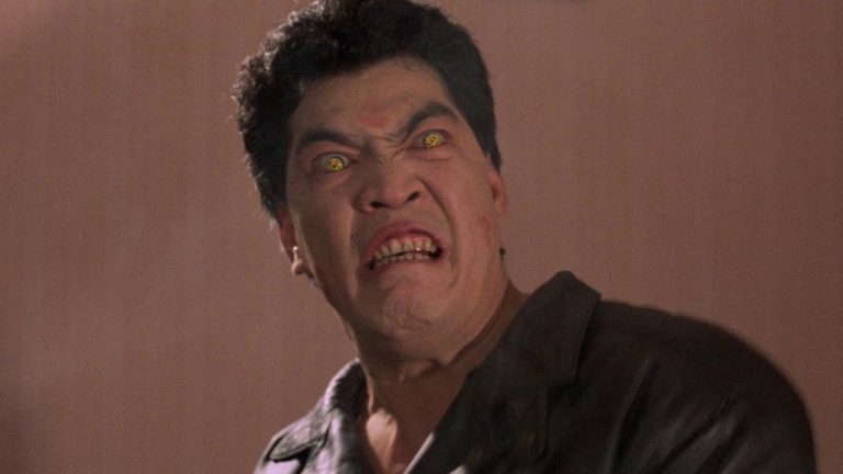 A man in a leather jacket with red eyes.
