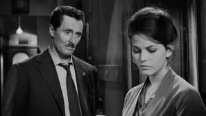 ‘The Facts Of Murder’ Blu-Ray Review – A Masterfully Crafted Italian Murder Mystery A black and white photo of a man and woman in a suit.