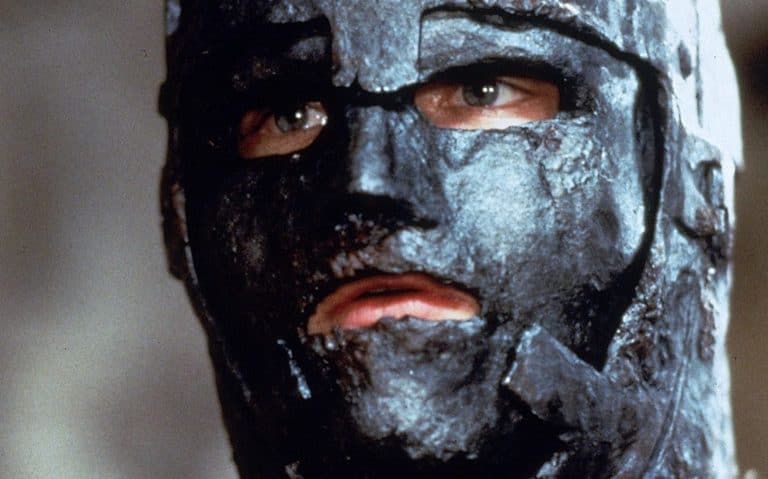A close up of a man wearing a mask.