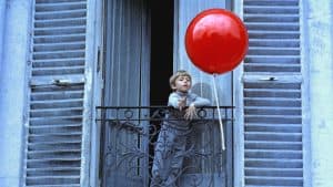 ‘The Red Balloon’ & Other Stories: Five Films By Albert Lamorisse Criterion Collection Blu-Ray Review – Essential Whimsy A boy holding a red balloon on a balcony.