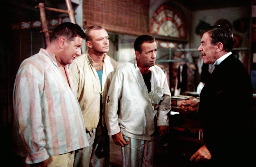 A group of men in a room talking to each other.
