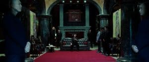 A group of people standing in a room with a red carpet.