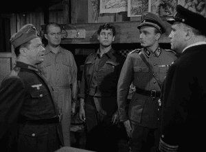 A group of men in military uniforms talking to each other.