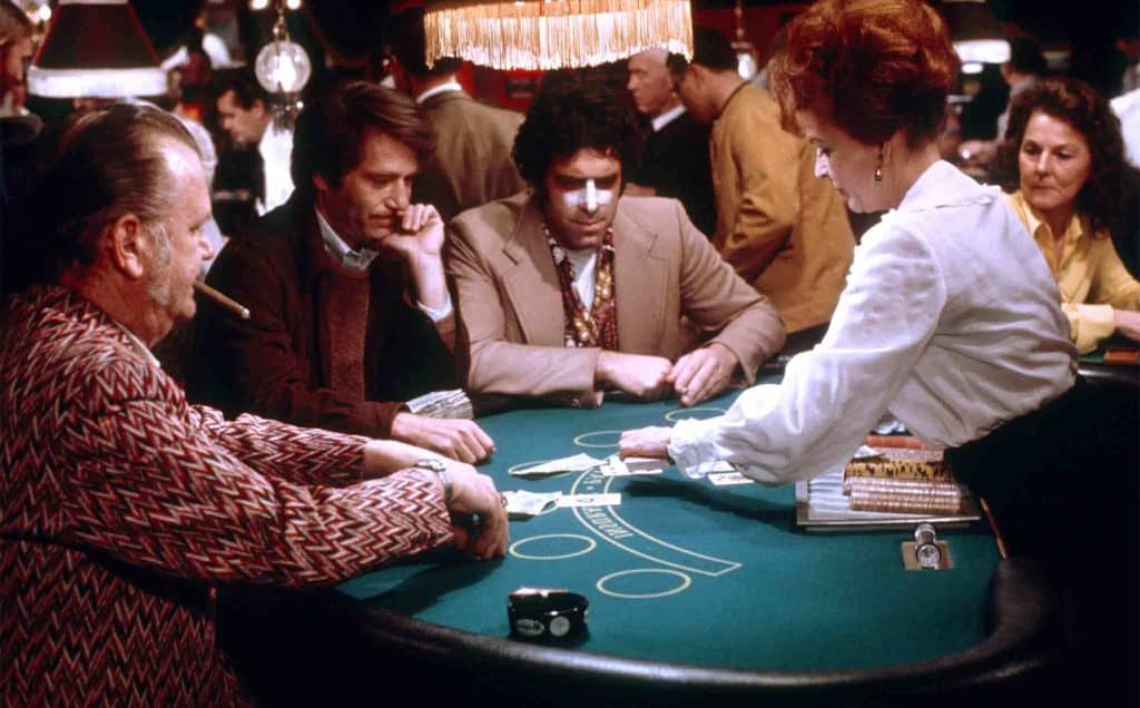 A group of people playing a game of baccarat.
