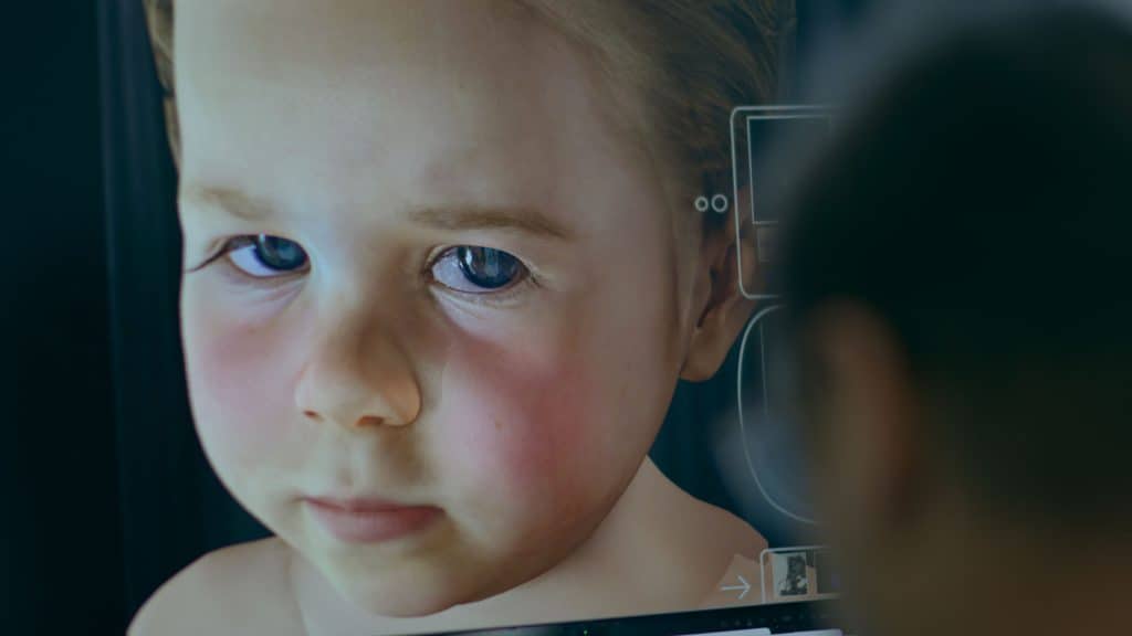 An image of a child looking at a computer screen.
