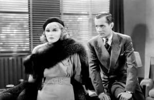 ‘Faithless’ (1932) Blu-Ray Review – Tallulah Bankhead Commands The Camera In Pre-Code Drama A man in a suit and a woman in a fur coat.