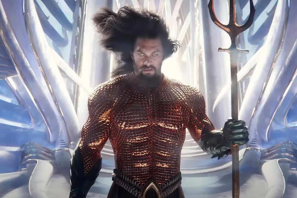 Aquaman is holding a spear in front of a white background.