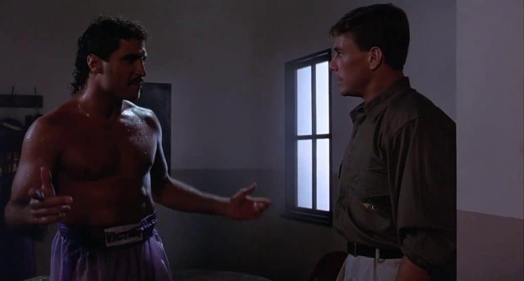 A man talking to another man in a boxing ring.