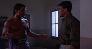 A man talking to another man in a boxing ring.