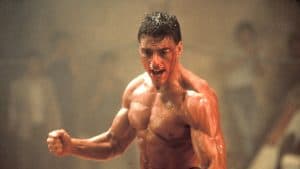 A man in a gym with his fists raised.