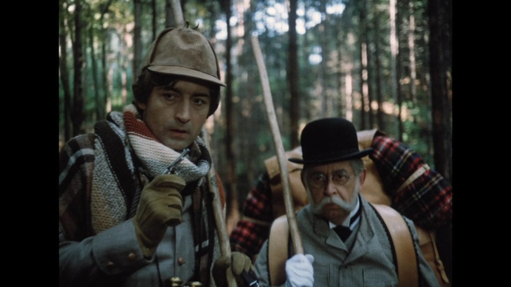 Two men in hats and hats in the woods.
