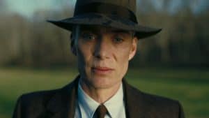 A man in a hat is standing in a field.