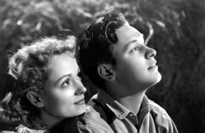 ‘Our Town’ (1940) Blu-Ray Review – Classic Stage Play Gets A Heartfelt Adaptation A black and white photo of a man and woman staring up at the sky.