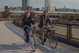 ‘Perfect Days’ Criterion Collection 4K UHD Blu-Ray Review – A Sublime & Patient Exploration Of Humanity A man and a woman riding bicycles.