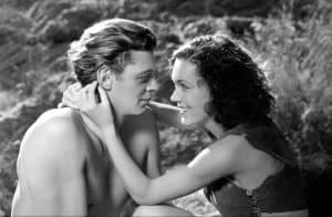 ‘Tarzan, The Ape Man’ (1932) Blu-Ray Review – The Visceral Pre-Code Debut Of Johnny Weissmuller A man and a woman in a black and white photo.