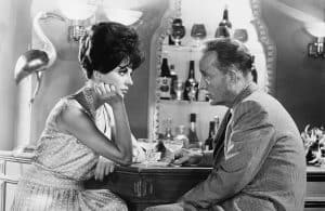 A man and a woman sitting at a bar.