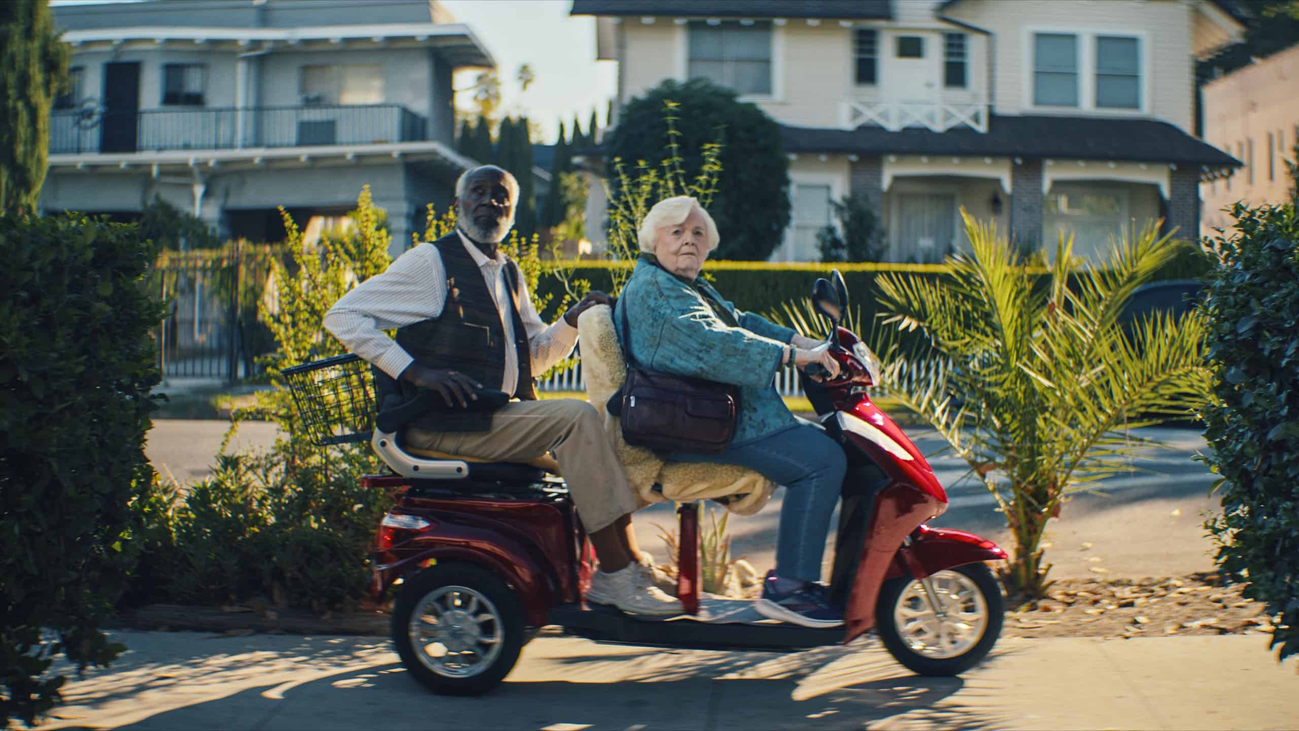A man and woman on a scooter.