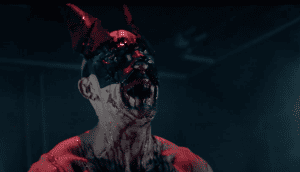 A demon with horns and blood on his face.