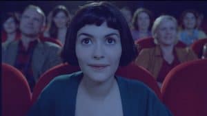 A woman in a theater looking at the audience.