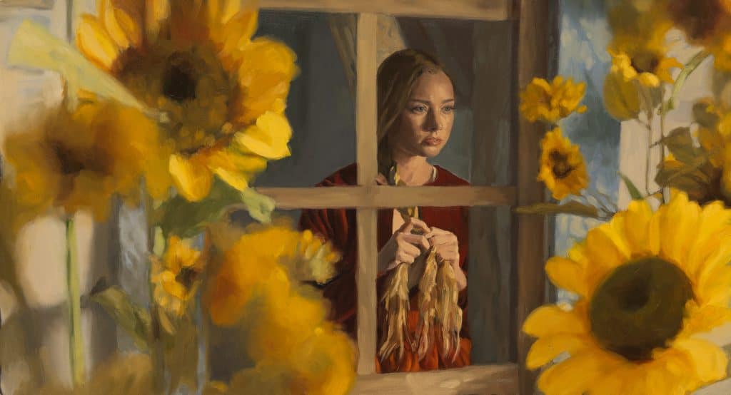 A woman looking through a window.