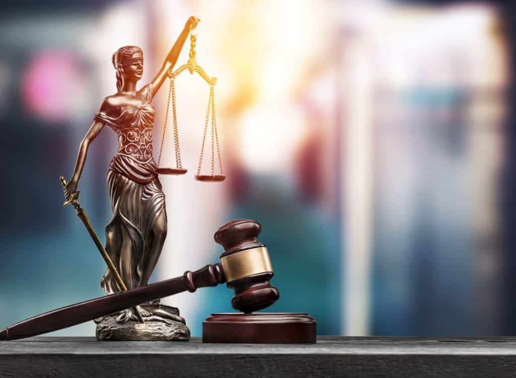 A statue of a woman holding a scale and a gavel.