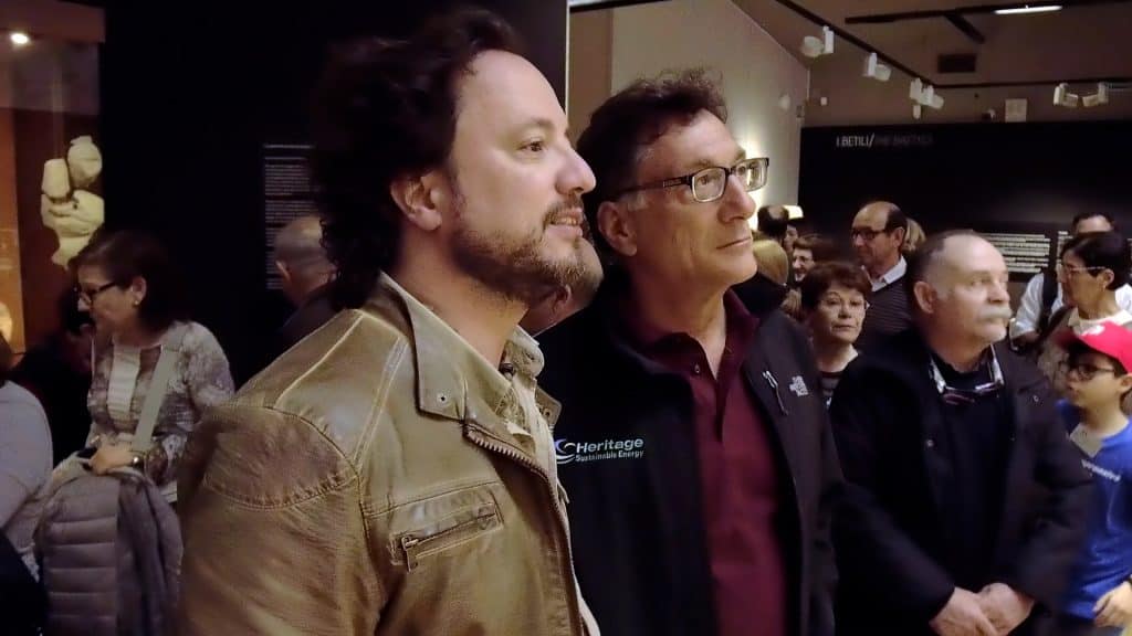 Two men standing in front of a crowd of people.